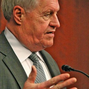 Man speaking into microphone at conference