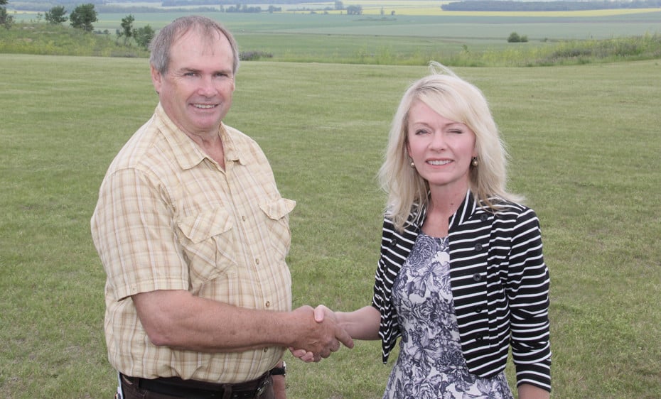 Murray Seymour, chair of the Pembina Valley Conservation District, and Candice Bergen, MP Portage Lisgar and minister of state social development, shake hands at Alexander Ridge Park atop the Manitoba Escarpment west of Miami, Man. July 8, following the announcement of the new Escarpment Habitat Protection Program. Landowners along the Manitoba Escarpment between the border and Riding Mountain National Park are being sought to voluntarily preserve their property, or parts of it, in a natural state in return for a one-time payment or tax receipt.