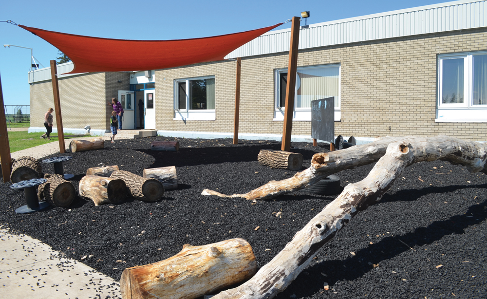 The school has created an outdoor classroom with a number of natural aspects, a chalkboard and sunshade.