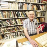 Leigh Syms, retired associate curator of archeology at the Manitoba Museum, holds a replica of a bone hoe once used by First Nations farmers. Photo: Shannon VanRaes