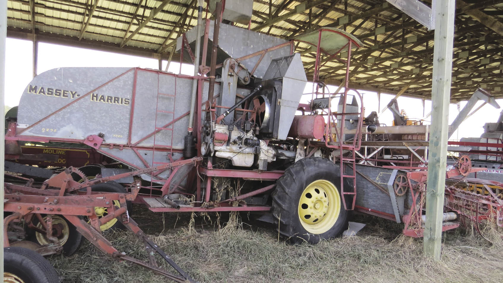 The museum’s Model 20 combine in storage. As can be seen, the engine was placed on the right side of the machine where it was very accessible though exposed to the elements. For 1938 the machine offered the ultimate in operator comfort, a sunshade over the operator’s position.  Photo: Manitoba Agricultural Museum 