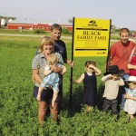 Sue and Larry Black (l to r) and their son David and his wife Ashley, pictured here with David and Ashley’s children Tucker, age one (held by Sue), Briar, age five, Jackson age four and Thomas age two,  hosted their centennial celebrations on their Deloraine farm August 4.