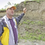 Looking back in time. David Lobb, the University of Manitoba’s senior research chair, watershed systems, and professor, landscape ecology, explains some of the geology in the South Tobacco Creek Watershed July 22 to scientists attending the joint meeting of the Canadian Society of Soil Science, Manitoba Soil Science Society and Canadian Society of Agricultural and Forest Meteorology.