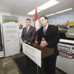 Manitoba’s agriculture minister, Ron Kostyshyn, makes an announcement about food safety, while MP James Bezan looks on.