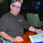 Dave Garabed holds a copy of the Winnipeg Evening Tribune from Aug. 8, 1923 that contains a short report of three Armenian youths brought to Canada by the Salvation Army. One of them was his father, Harry. 