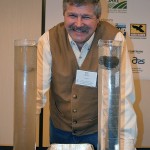 Soil scientist Jon Stika demonstrates the erosion-resistant qualities of a “living” soil aggregate (r) compared to an ordinary clump of “dead” dirt.