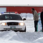 Residents speaking to an RCMP officer in his cruiser.