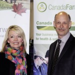 Man and woman standing in front of promo banners.