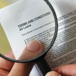 Magnifying glass looking at contract.