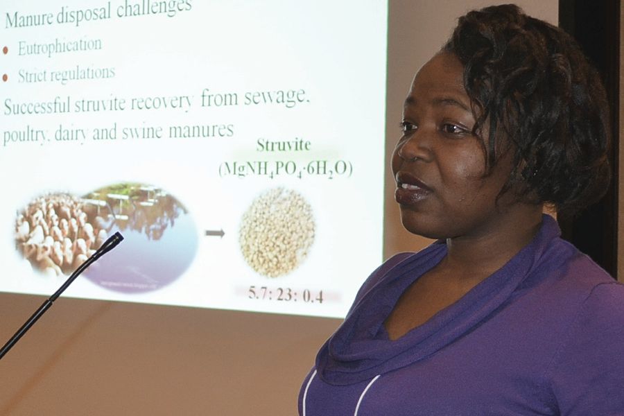 Woman presenting at a podium with microphone.