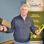 Terry Ackerman, CEO of the Canadian Lamb Producers Co-operative, holds up an RFID wand and an electronic grading device, two new technologies that he believes will help the co-op unlock more of the value in Canadian lamb.