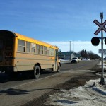 A school bus crosses one of three rail crossings in Souris.