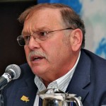 Man speaking into microphone at conference