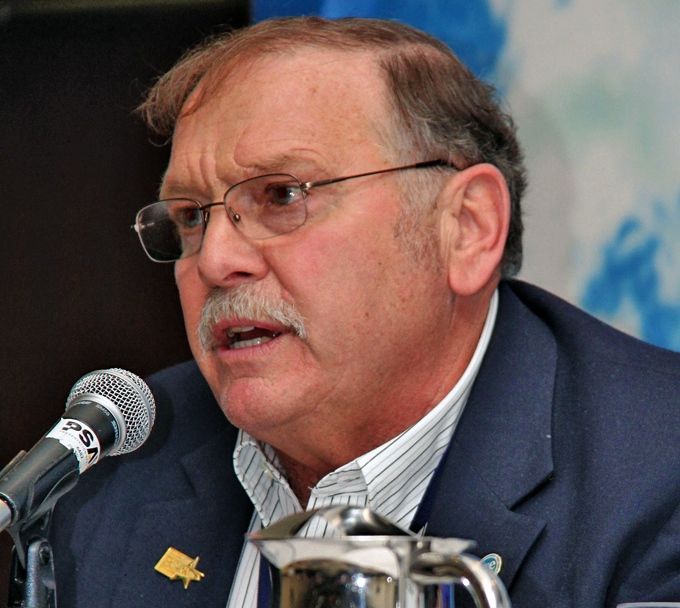 Man speaking into microphone at conference