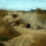 A dirt bike operator hitting the dirt.