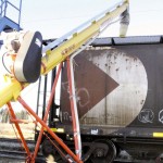 Grain auger filling a railway car with grain.