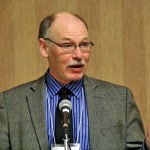 Man speaking at press conference.