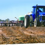 Tractor applying fertilizer to a field.