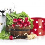 a bunch of radishes and water cans