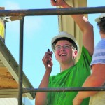 young man helping build a house
