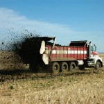 Large truck in a field spreading manure
