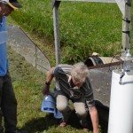 Don Cruikshank demonstrates how field runoff water samples are collected.