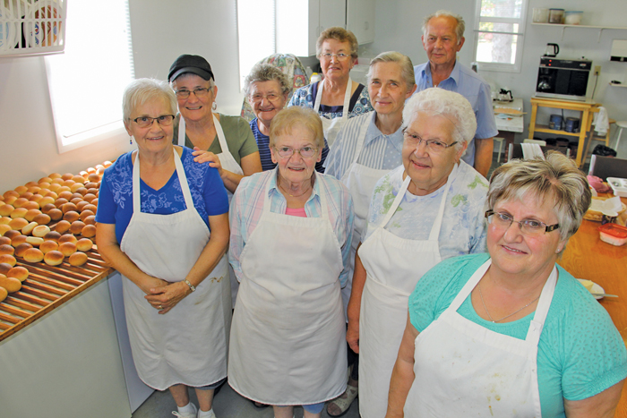 These eight women make up half the current number of Valley Harvest Maids, a non-profit group of volunteer cooks who’ve been baking and cooking traditional meals at the Pembina Threshermen’s Museum since the late 1960s. Pictured (l to r) are Judy Thiessen, Esther Wieler, Mary Penner, Tina Holenski, Gert Hiebert, Katharina Peters, Mary Zacharias and Tina Friesen. Jake Buhler, in back, is the vice-president of the Pembina Threshermen’s Museum who was helping out in the kitchen last week.  PHOTO: LORRAINE STEVENSON