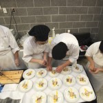 a group of culinary students preparing food