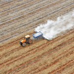 tractor fertilizing a crop as seen from above