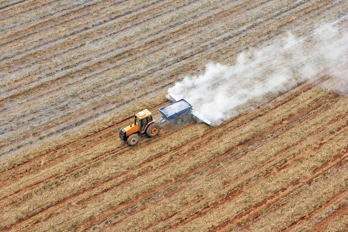 tractor fertilizing a crop as seen from above