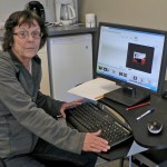 Beverley Anderson sitting at her computer
