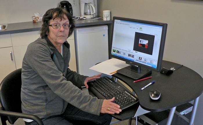 Beverley Anderson sitting at her computer