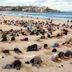 A group of around 400 demonstrators participate in a protest by burying their heads in the sand at Sydney’s Bondi Beach Nov. 13. Hundreds of protesters participated in the event, held ahead of the Nov. 15 G20 summit in Brisbane, which was being promoted as a message to Australian Prime Minister Tony Abbott’s government that, “You have your head in the sand on climate change.”