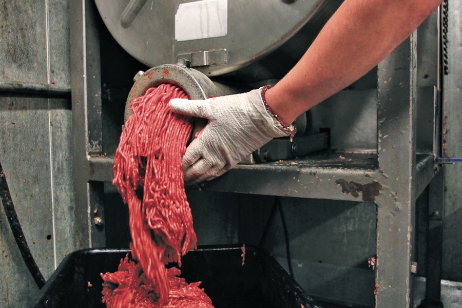 ground beef exiting a meat grinder