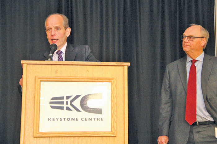 two men at a podium during a presentation