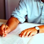 man at desk with paperwork