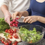 people prepping a vegetable salad