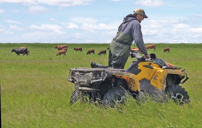 man riding a quadrunner