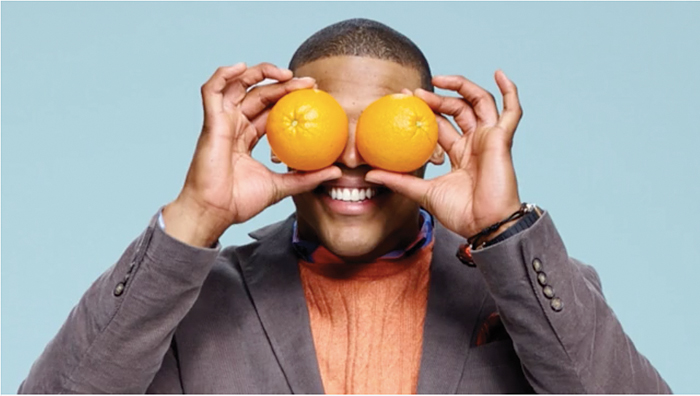man with oranges in front of his eyes