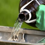 pouring a chemical pesticide