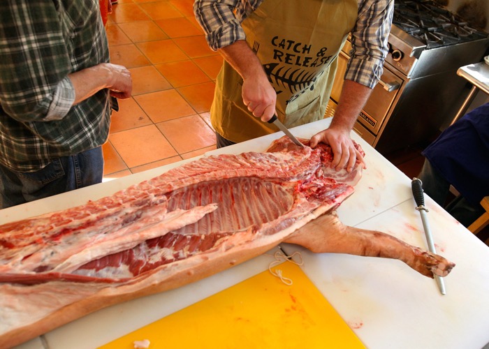 Kevin Mitchell makes his first attempt at butchering during the event held at The Food Studio in Winnipeg.