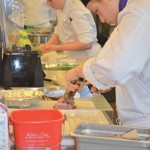 Culinary student, Victoria Clifford slices into her seared duck breast in preparation to plate her appetizer during the Manitoba Canola Growers Association’s Black Box Challenge.