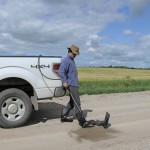man spraying disinfectant on boots