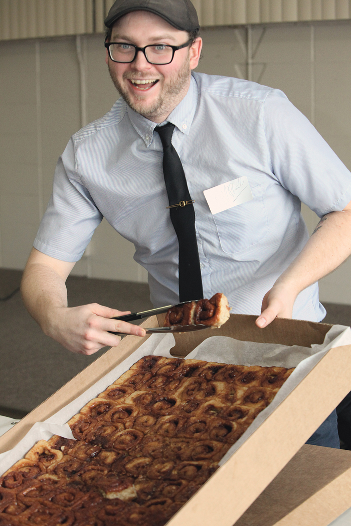 man with tray of cinnamon buns