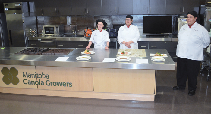 Kelsie Gardner, Glenda Halkett and Dallas Stevenson wait patiently for judging results in the Manitoba Canola Growers culinary theatre.