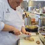Dallas Stevenson slices into his stuffed pork tenderloin with arbore rice prior to plating his entrée.
