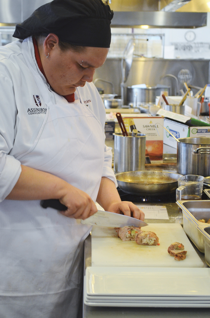 Dallas Stevenson slices into his stuffed pork tenderloin with arbore rice prior to plating his entrée.