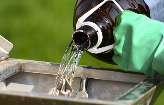 pouring farm chemicals