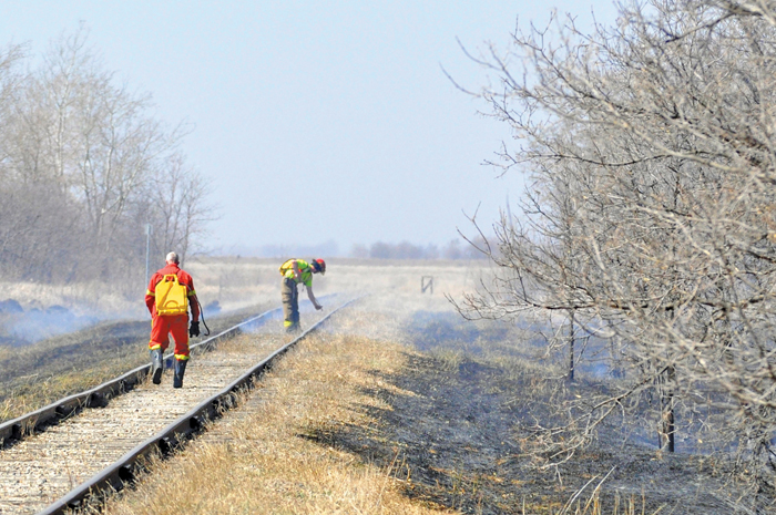 firefighters putting out a grass fire