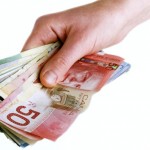 A hand full of Canadian Cash